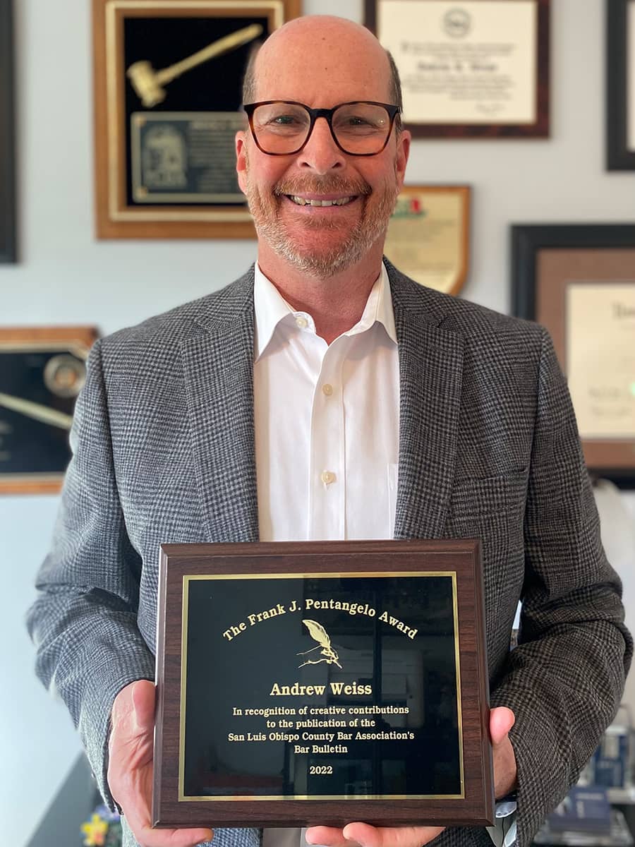 Andrew Weiss holding a Pentangelo award